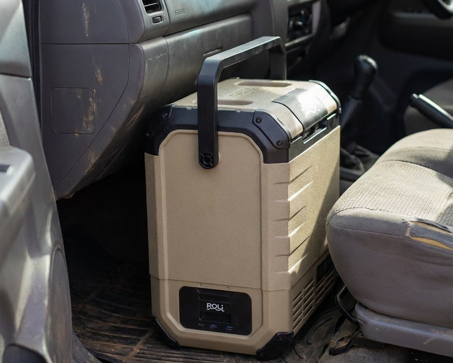 ROLi Mini 10L portable fridge on the passenger floor of a vehicle